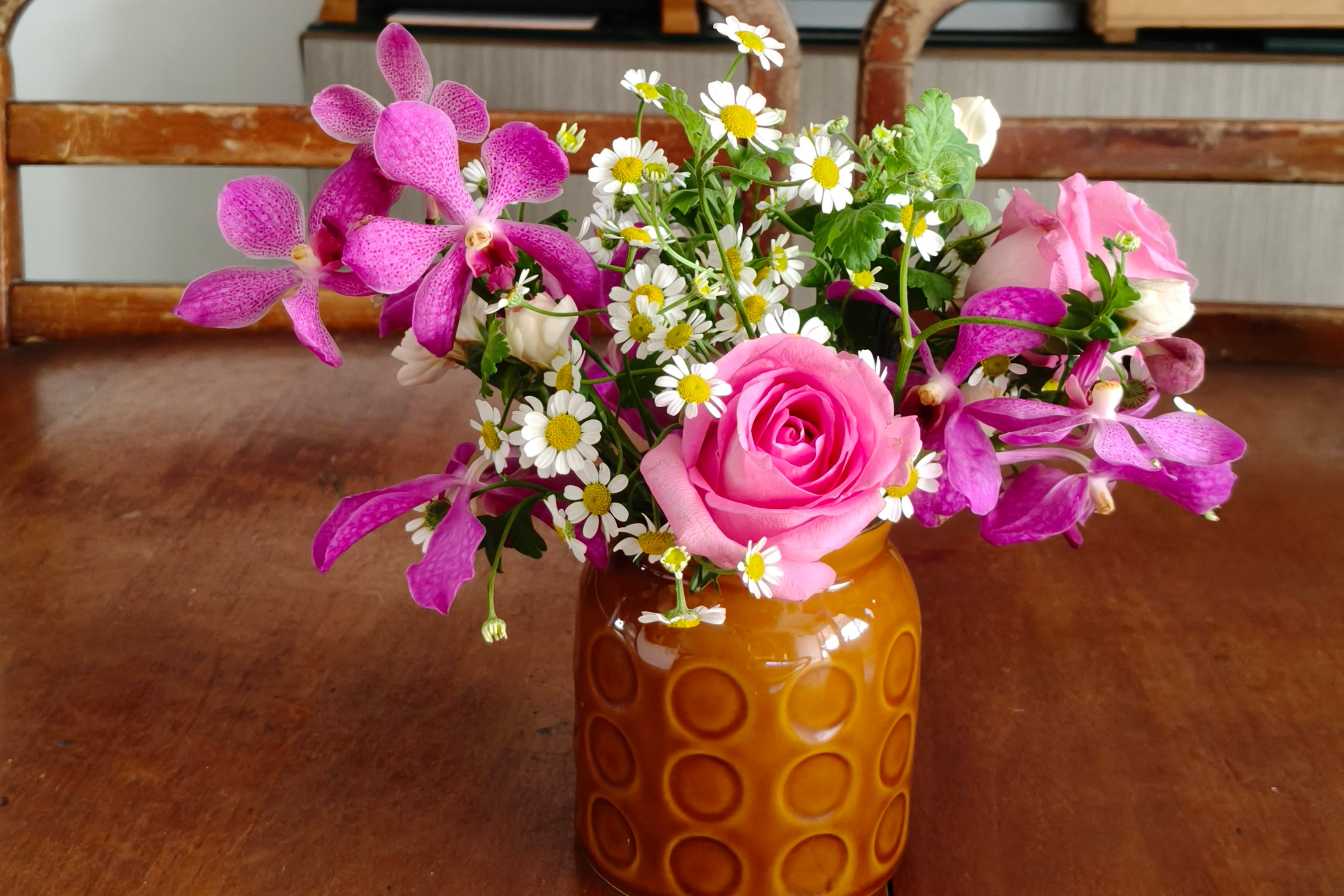 Fresh flowers displayed in a home setting, on a dining table