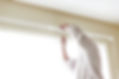House painter reinstalls a drapery rod RM