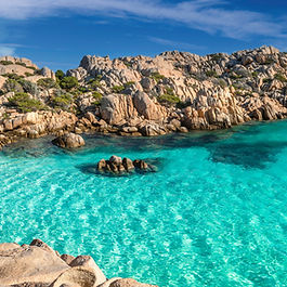Na ponta nordeste da Sardenha , existe um pedaço de terra que mais parece pintura. São as  ilhas do Arquipélago de La Maddalena : uma coleção de cerca de 60 ilhotas espalhadas por águas  que, quem vê de perto, jura ter mais de trinta tons de azul . Não é exagero. O mar aqui tem mesmo  um brilho diferente . E não à toa, o arquipélago foi declarado parque nacional em 1994 , tamanha a importância ecológica e a beleza cênica da região. As Sete Irmãs Apesar do número elevado de ilhas,  sete delas se destacam  – e ganharam até apelido: são as “Sete Irmãs” do arquipélago. La Maddalena  é a maior e mais habitada, com um centrinho charmoso e clima de cidade portuária. Caprera , ligada à ilha principal por uma ponte, mistura trilhas e enseadas desertas.  Spargi, Budelli, Santa Maria, Razzoli e Santo Stefano  completam o conjunto. Cada ilha tem sua própria personalidade . Budelli, por exemplo, ficou famosa por sua Spiaggia Rosa  – uma praia de areia rosada cuja visitação foi restringida para preservar o ecossistema . Já Caprera guarda a casa-museu de Giuseppe Garibaldi , um dos nomes mais importantes da unificação italiana , que viveu ali seus últimos anos. Navegar é preciso Durante o tour, embarcamos em um passeio de barco  para conhecer algumas dessas ilhas de perto. Saindo do porto, a travessia revela paisagens que vão mudando conforme o movimento do sol  – ora turquesa, ora esmeralda, ora cintilante. A sensação é de ter descoberto um segredo guardado a muitas águas de distância . E talvez seja mesmo isso que La Maddalena entrega: a beleza de um Mediterrâneo que insiste em parecer intocado . Conheça esse e outros destinos com a Domundo! Transformamos viagens  em experiências  que conectam pessoas, lugares e culturas,  com um jeito único de fazer turismo: artesanal, cuidadoso e comprometido em estar sempre no lugar certo, na hora certa. Quer programar a sua próxima viagem? Fique por dentro dos nossos roteiros.