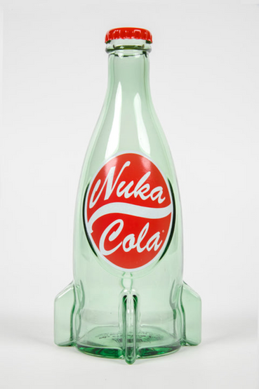 A glass replica of the Nuka-Cola from Fallout soft drink in the rocket bottle design as seen in Fallout 4 and in Fallout 76, with a cap on the lid and surrounded by 9 loose Nuka-Cola bottle caps