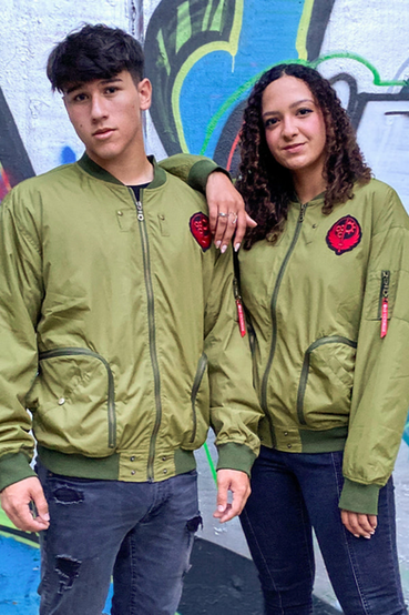 Brotherhood of Steel from Fallout themed bomber jacket with a sage green body and dark olive green accents. The bomber jacket has a black/red embroidered logo over the left chest, black symbol on the upper back collar, custom label on the inside of the back collar, and red pull tie with 'Ad Victoriam' screen printed in white on the left sleeve