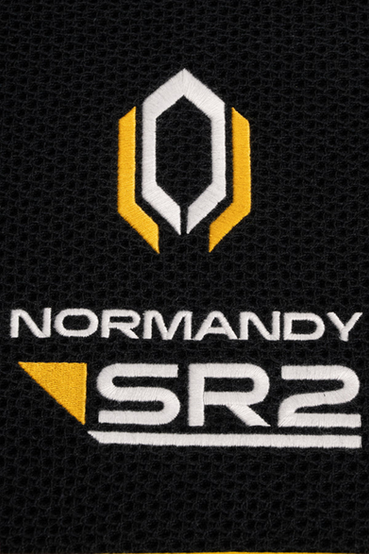 A set of 3 embroidered, black cotton waffle material kitchen towels featuring various logos from the Mass Effect series: Normandy SR1 with a red Spectre symbol and red contrast binding, Normandy SR2 with a blue Systems Alliance Navy symbol and blue contrast binding, and Normandy SR2 with yellow and white Cerberus symbol and yellow contrast binding. All text on the towels are embroidered in white, and on the other side of each towel the Mass Effect text logo is embroidered as well