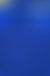 Fallout Baking Bundle that comes with: a blue apron with an all-over Vault Boy print and Vault-Tec logos, a Vault Boy thumbs up oven mitt, and a Power Armor helmet silicone mold, housed in a custom designed gift box