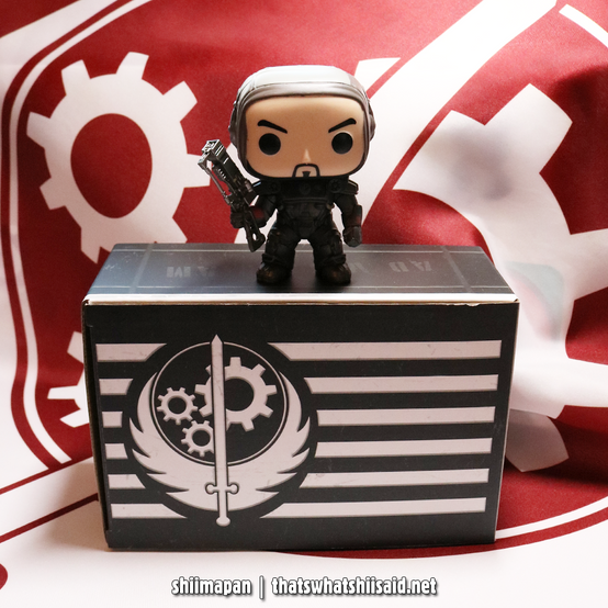 Paladin Danse from Fallout 4 Funko Pop! figure sitting on top of a small Brotherhood of Steel cardboard box