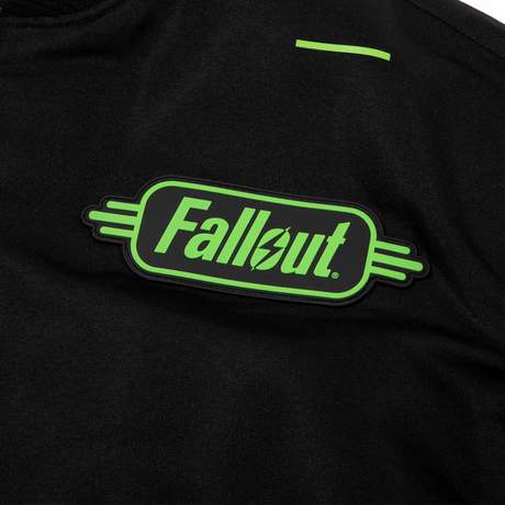 Black tactical bomber with a strap pouch in the back and various zippered compartments on the sleeves and front. Fallout text logo in bright green over the left chest on the front, Vault Boy VATS from Fallout is printed on the back in bright green, embroidered Vault Boy head patch in bright green on the left sleeve, and embroidered Vault-Tec patch on the right sleeve