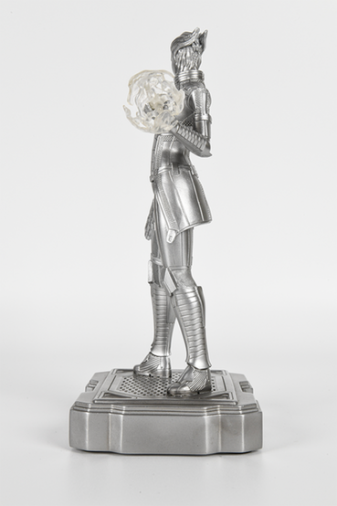 Silver variant of a Liara T'Soni from Mass Effect statue, of her wearing her default outfit in Mass Effect 3. She's holding a heavy pistol in her right hand, and activating biotics using her left hand