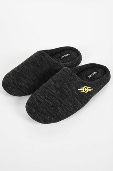 A pair of dark heathered grey house slippers with yellow embroidered Vault-Tec logos from Fallout on the outside of the slippers, and a repeating Vault-Tec logo pattern on the soles
