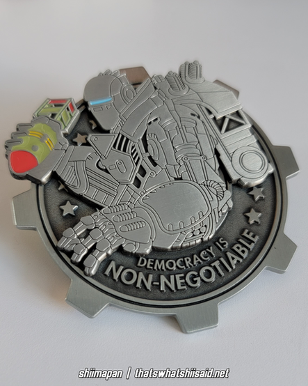 Liberty Prime from Fallout 4 large enamel pin, shown getting ready throw a mini nuke in his right hand. The mini nuke and his visor have colored enamel detail.