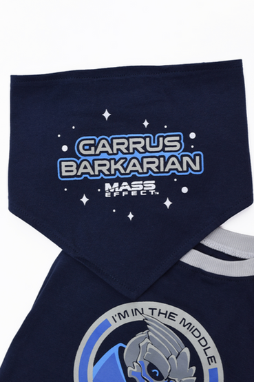 3-piece dog accessory set: dog shirt that has Garrus Vakarian from Mass Effect and text that says 'I'm in the middle (of some) Howlibrations' on the back, and a small Mass Effect text logo on the front. It also comes with two matching bandanas, one design says 'Garrus Barkarian' and the other says 'Barkangel' with the gold Archangel logo