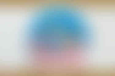 A real life collectible plastic snow globe based on Goodsprings as seen in Fallout: New Vegas. Vault Boy is shown with a pick axe slung over his left shoulder, with a house and windmill in the background. The snow globe has a clear plastic dome, with a white base that says GOODSPRINGS in capitalized red text on the front