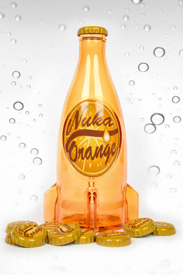 A glass replica of Nuka-Cola Orange from Fallout soft drink in the rocket bottle design as seen in Fallout 4 and in Fallout 76, the bottle itself is tinted orange, with the soda label being 'Nuka Orange' in a brown color with a orange slice background. Also pictured are loose metal bottlecaps that match the Nuka-Cola Orange soda label
