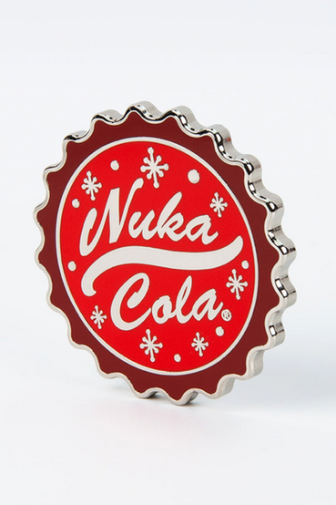 Oversized Fallout themed coin featuring scalloped edges to mimic a bottle cap, the signature Nuka-Cola logo on one side, and the Nuka-World mascots Bottle and Cappy on the other side with text that says: Your Thirst Comes First! The oversized coin comes housed in a velvet clamshell display box