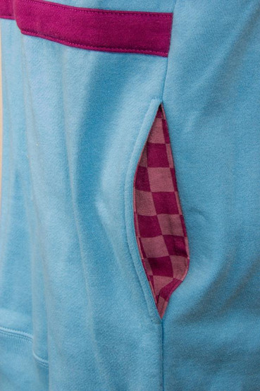 Detail shot of the side seam pocket showing the contrasting purple checkered lining of the pocket