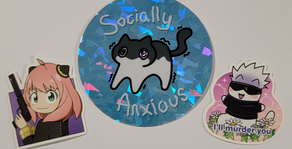 Stickers of Anya from Spy x Family posing with Loid's gun, Socially Anxious cat, and Gojo Satoru from Jujutsu Kaisen as a cat running through a flower field with text at the bottom that says: I'll murder you