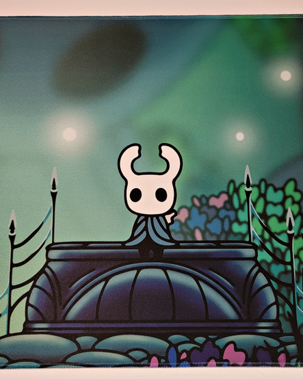 Cropped photo of a large oversized mouse pad showing The Knight (main character) sitting on a bench