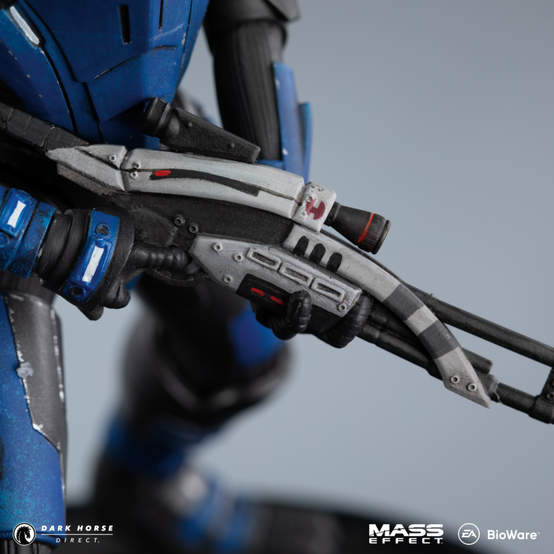 PVC figure of Garrus Vakarian from Mass Effect, sporting his Mass Effect 2 gear before you acquire him in your squad, trusty sniper rifle in hand, standing on top of a black base with the Paragrade (Paragon and Renegade morality symbols combined)