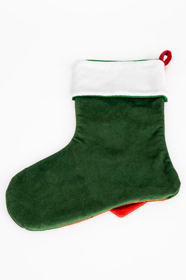 Holiday themed stocking and ornament set featuring Dogmeat from Fallout 4. The stocking shows a portrait of Dogmeat sticking his tongue out while wearing reindeer horns, surrounded by holly, snowflakes, and festive lights. He's also wearing a Vault 111 bandana that overlaps the stocking. The matching ornament features Dogmeat wearing his signature goggles, with a grey ribbon for hanging