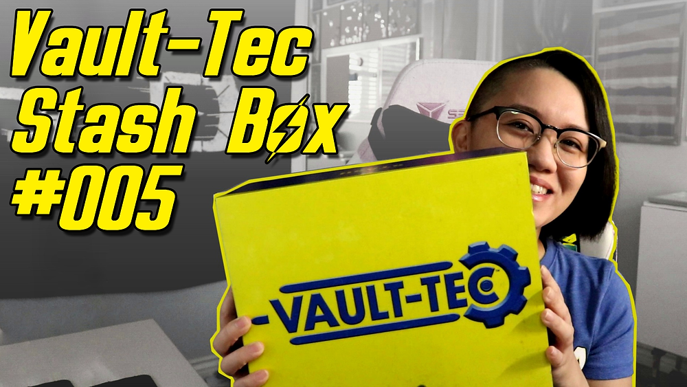 a girl with short hair and glasses holding up a Vault-Tec Stash Box from Fallout by Bethesda Gear, with the text 'Vault-Tec Stash Box 005' in yellow text in the upper left corner