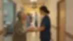 In a warm wound clinic hallway, an elderly patient hands a plate of cookies to the nurse practitioner who treated her as the supervising physician approaches behind them — the person thanked and the name on the orders, side by side.