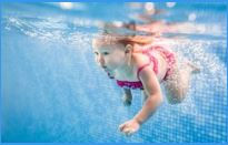 A young child searching for toys underwater