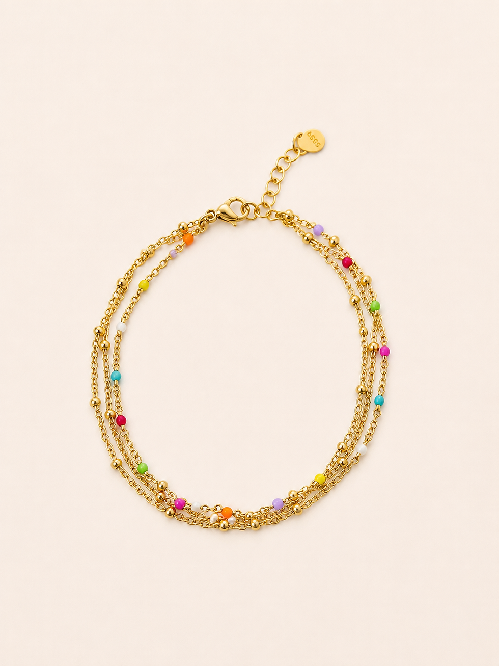 Une chaîne de cheville dorée, fine et colorée, parfaite pour illuminer les chevilles tout l’été. Ses petites perles multicolo