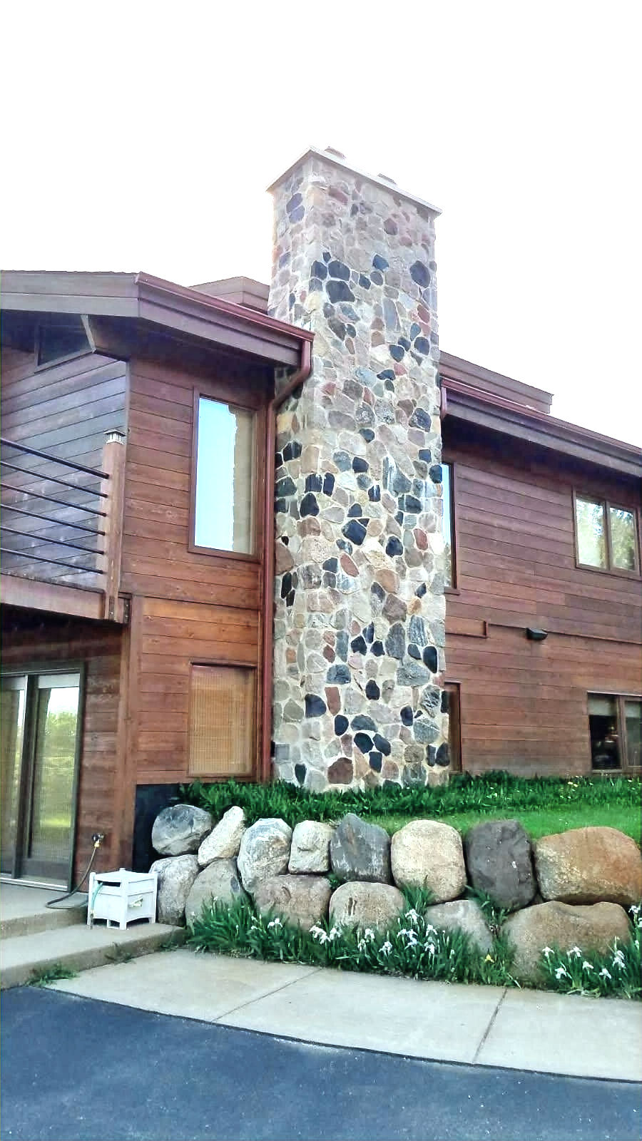 ubl masonry stone chimney on a wooden house