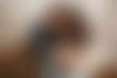 Mom and dad looking down towards newborn baby boy