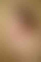 A newborn boy sleeping soundly on a light yellow blanket