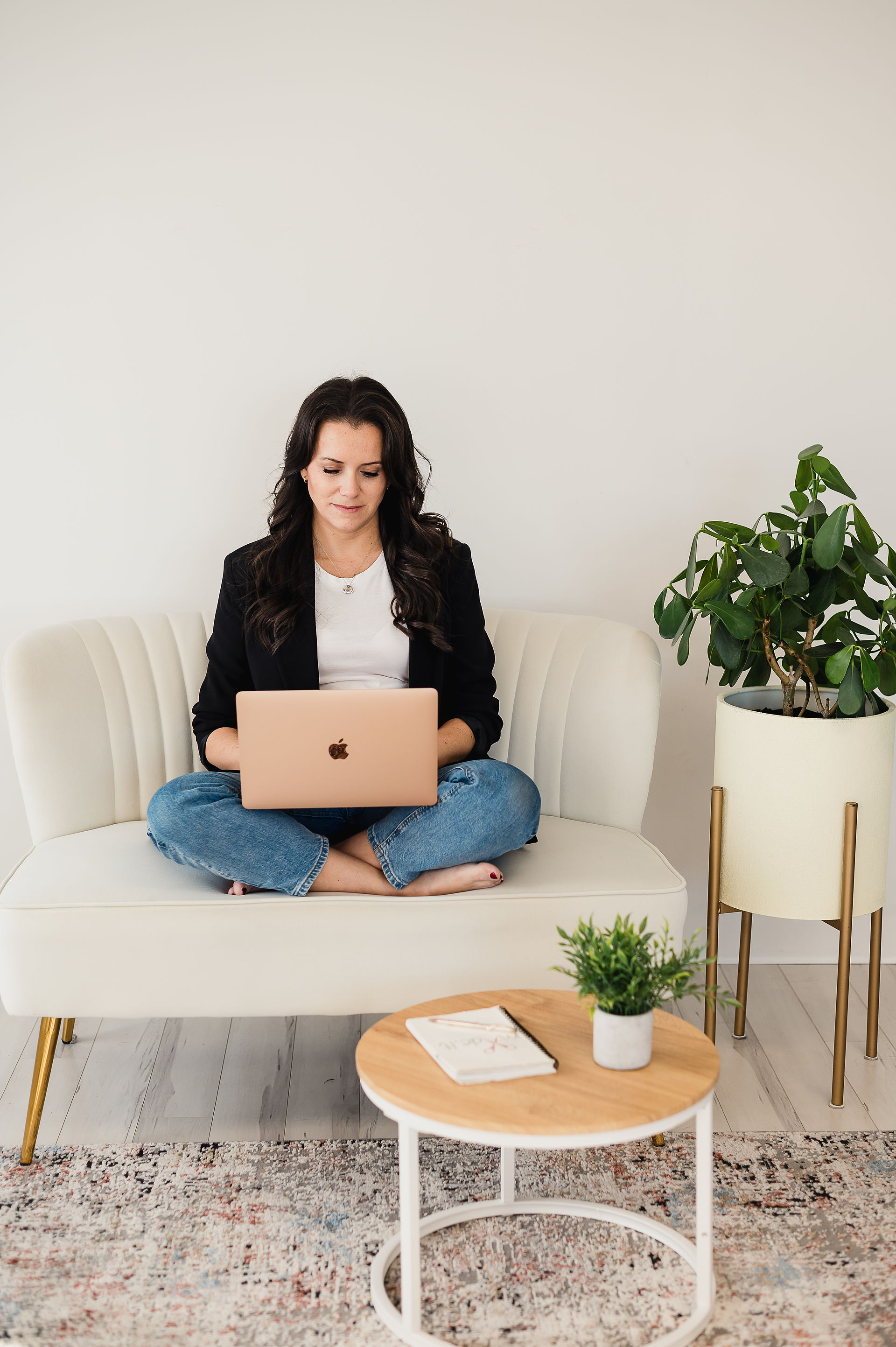 girl sitting down and working on her laptop 
