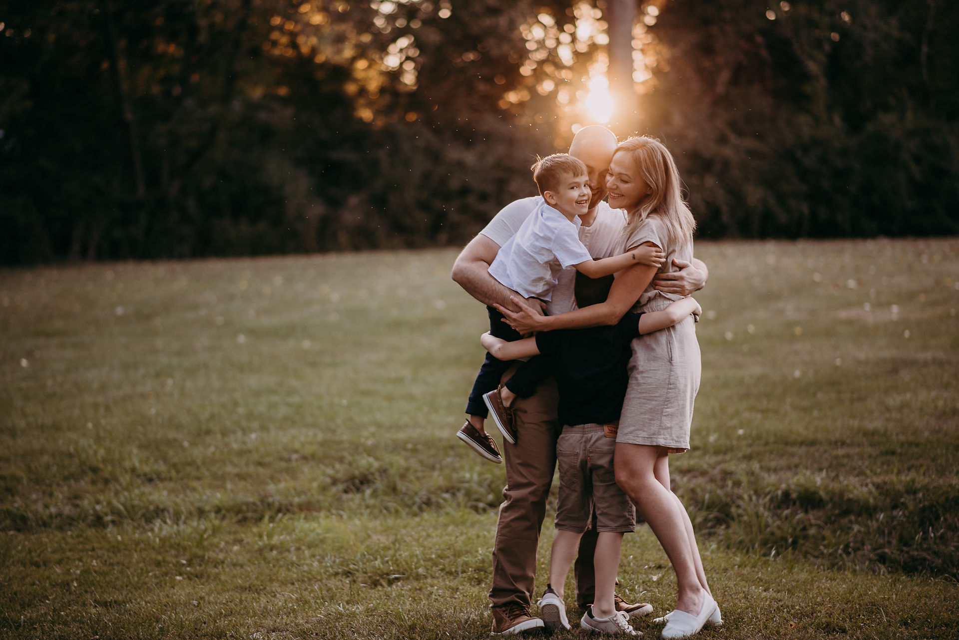 family hug at golden hour