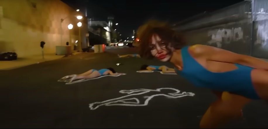 Rising from her own chalk outline as death, performance, and rebirth collapse into one. Credit: Still from Korg Funk 5 (dir. Nadia Lee Cohen and Charlie Denis, 2025)