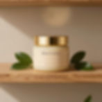 Cream jar with gold lid and green leaves on shelf