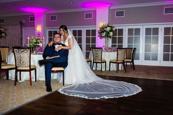 During the NYC wedding photo session, the groom wore a blue suit while the bride donned a white dress and a long veil.