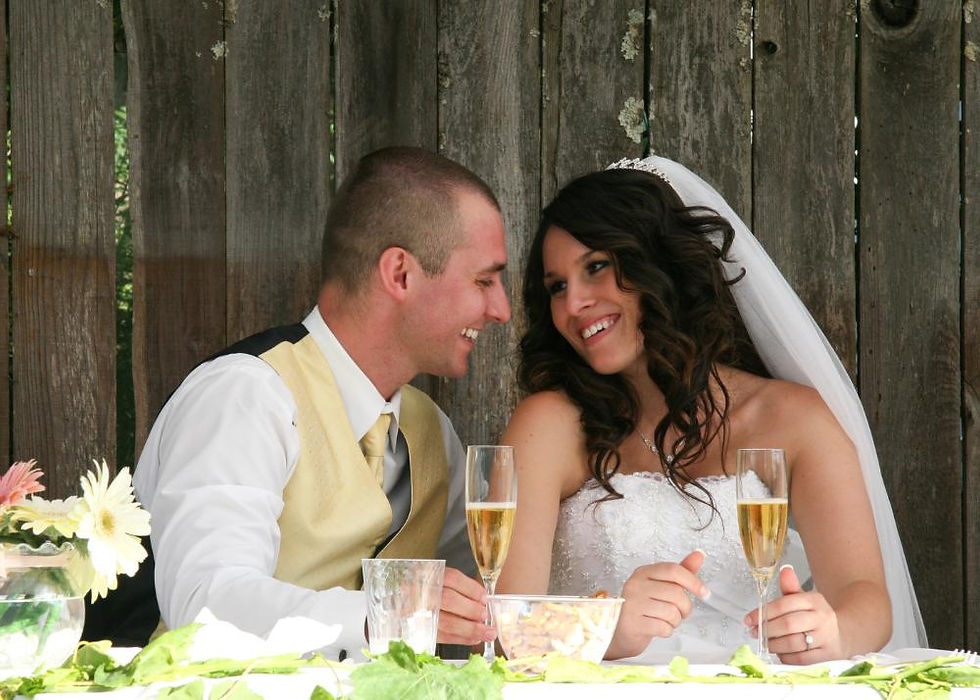 Candid moment: New Jersey wedding couple laughs while holding champagne glasses in a joyful photograph.