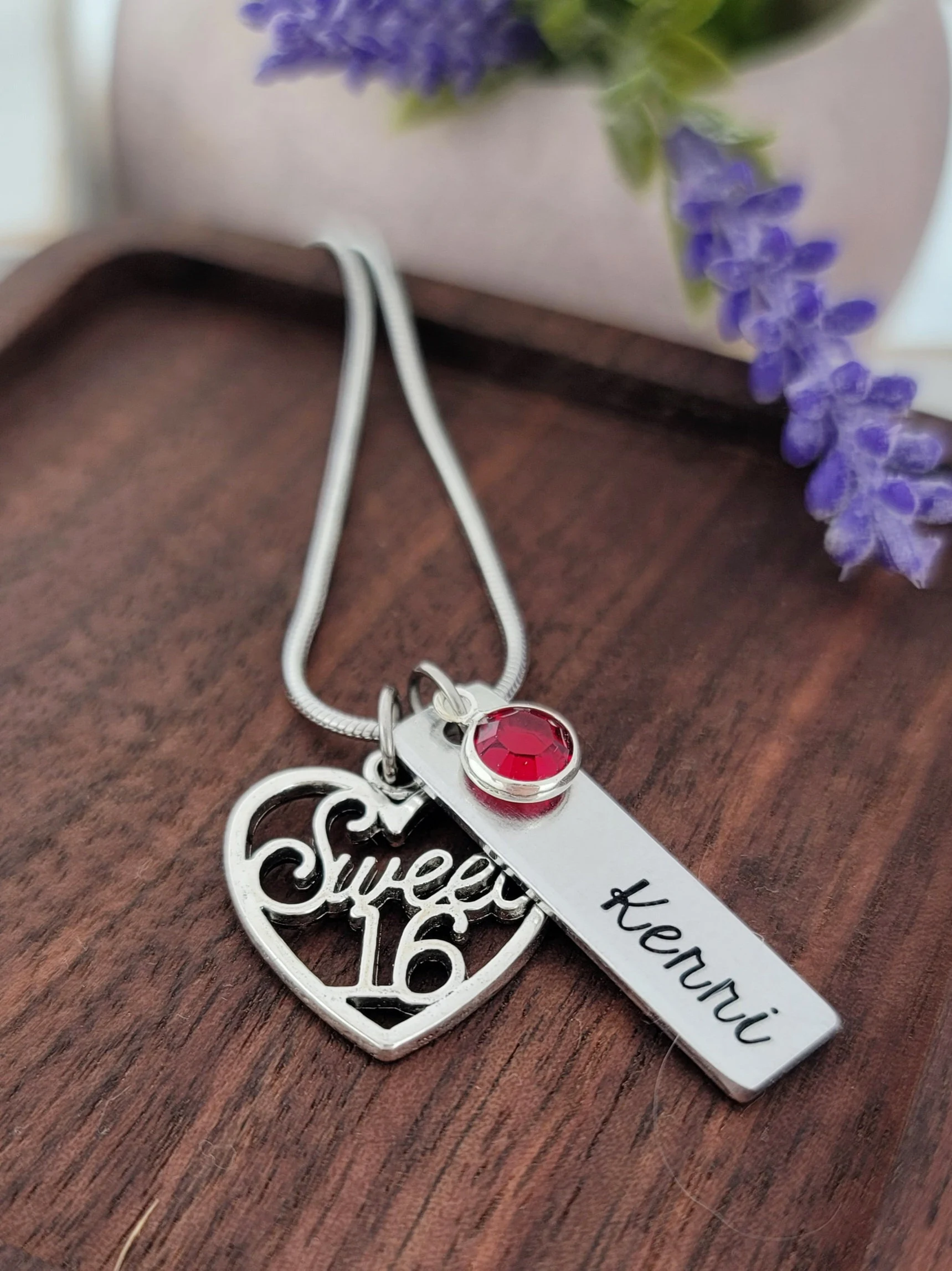 This silver Sweet 16 custom name necklace with a heart shape is featured in the Top 20 Sweet 16 Gift Ideas, perfect for adding a personalized touch of elegance to any outfit.