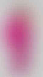 "In a pink jumpsuit, a girl poses with both hands on her waist during a Sweet 16 photo shoot in Brooklyn, NY.