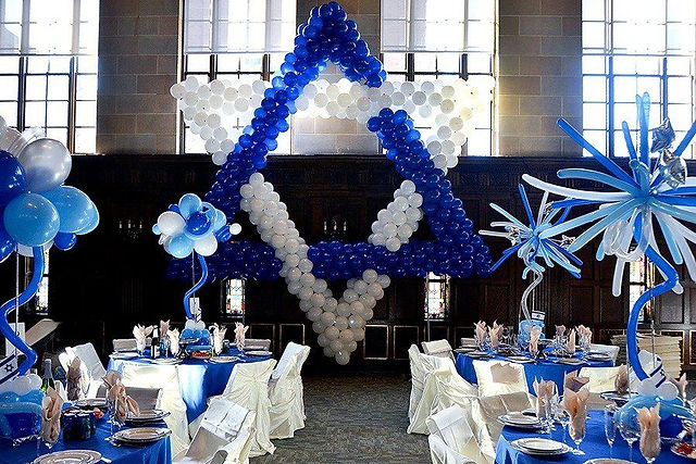 Bar Mitzvah party decoration featuring blue and white balloons arranged in the shape of a star. The event took place at a synagogue in New York City, with the festive setup adding to the celebratory atmosphere.
