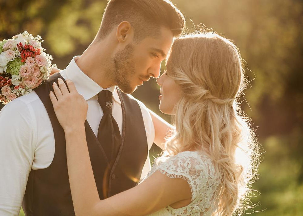 Classic wedding pose: Couple tenderly touching foreheads.