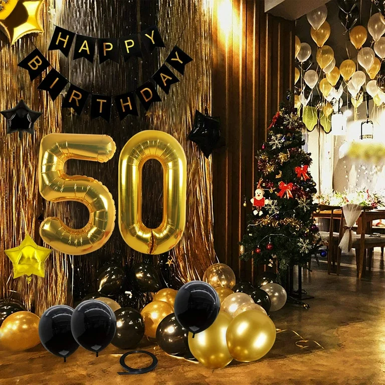 Black and gold decorations for a 50th birthday, featuring number 50 balloons along with regular black and gold balloons.
