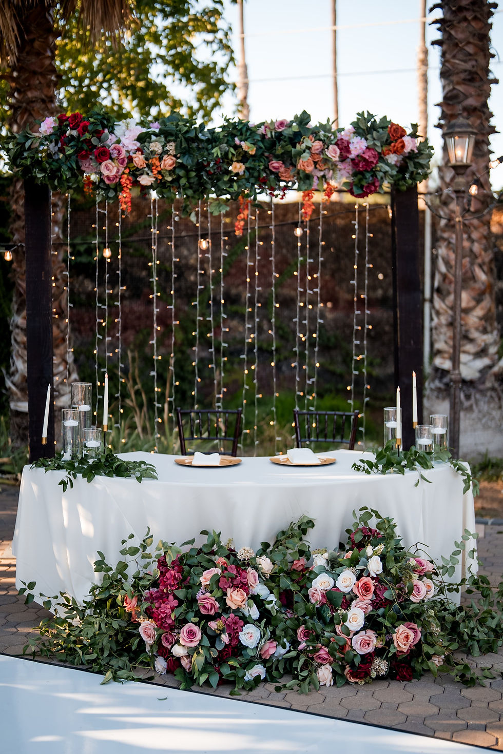 Outdoor wedding dinner in lush gardens at Brownstone Gardens, Bay Area.