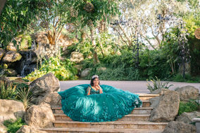 Quinceañera posing in her gown along the garden pathway at Brownstone Gardens.