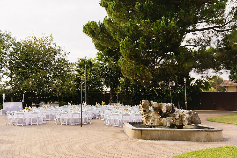 Outdoor wedding dinner with string lights at Brownstone Gardens garden.