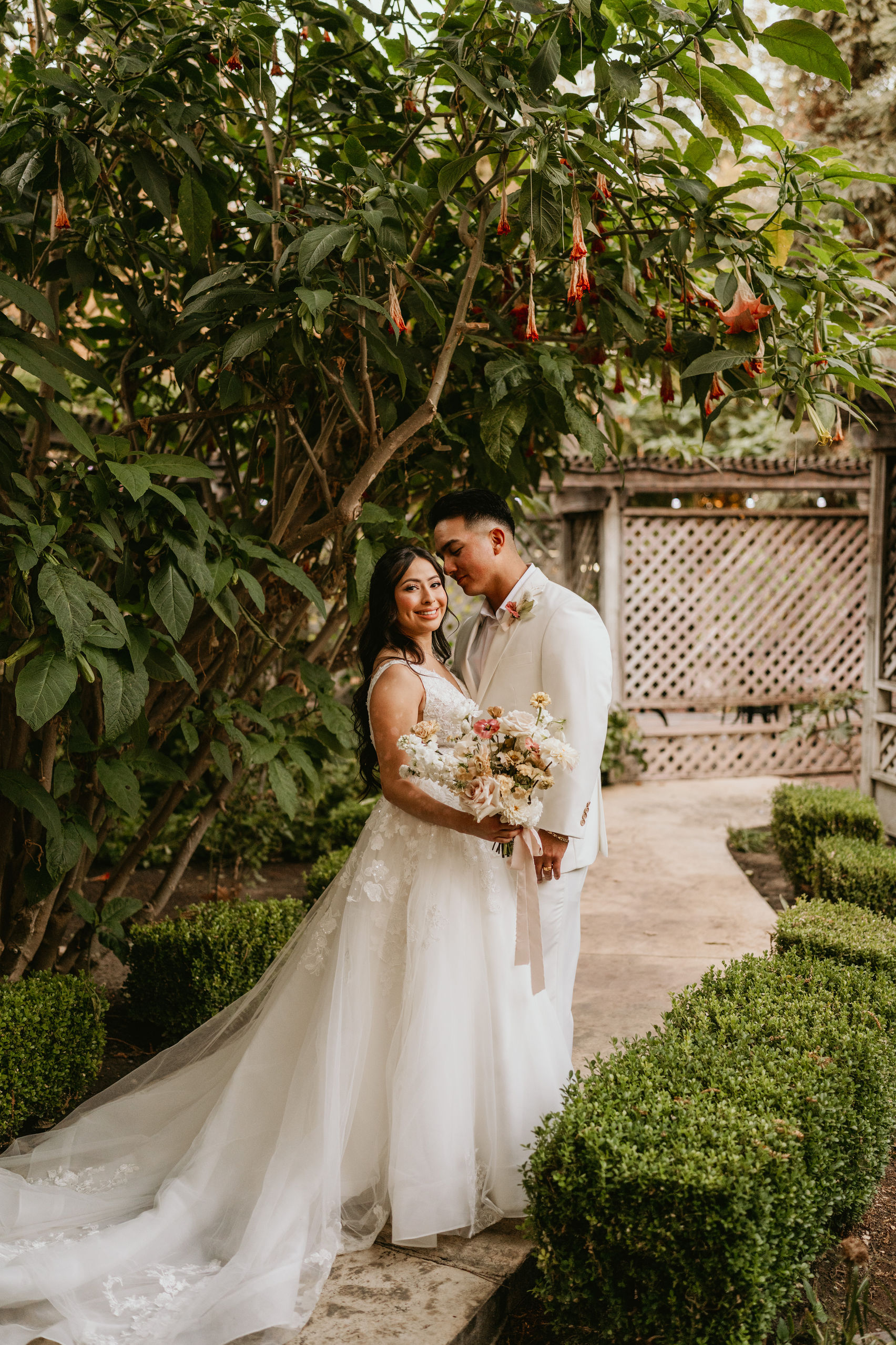 Rose Garden entrance at Brownstone Gardens with vibrant roses lining the walkway, ideal for weddings, events, and couples’ photos.
