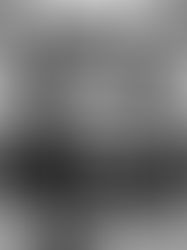 A young female 1920s usherette offering sweets and programmes from a tray