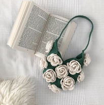 A green crochet bag with roses