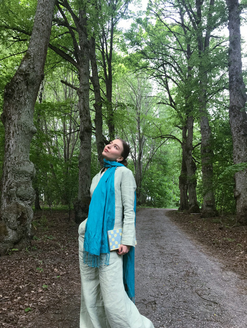 A girl in a green linen suit and a blue scarf.