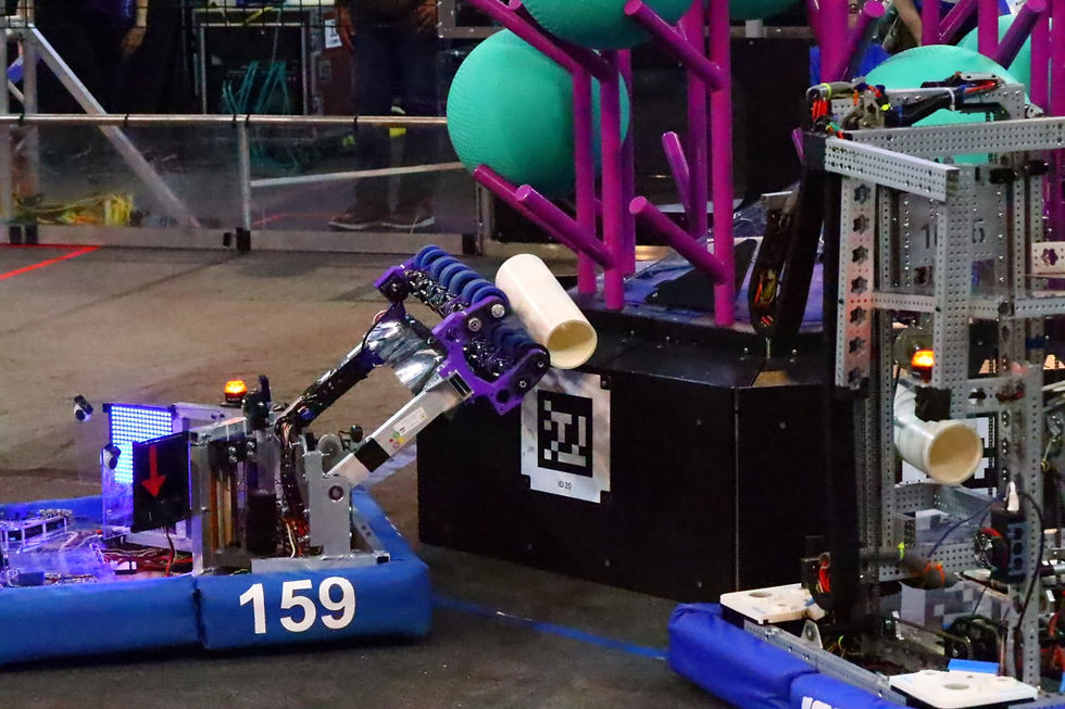Robot scoring into the reef (Simon/159 Team Member)