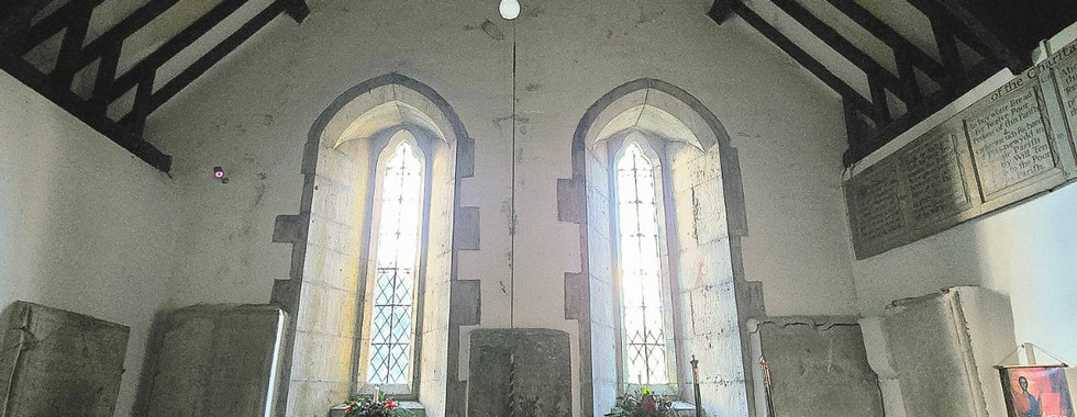 Interior of St. Digain's Church with wooden pews and beamed ceiling.
