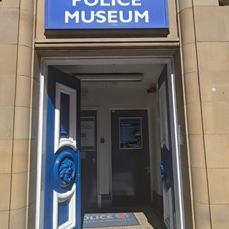 Entrance to Greater Manchester Police Museum with blue sign.