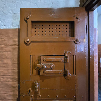 Heavy Victorian cell door at Manchester Police Museum.